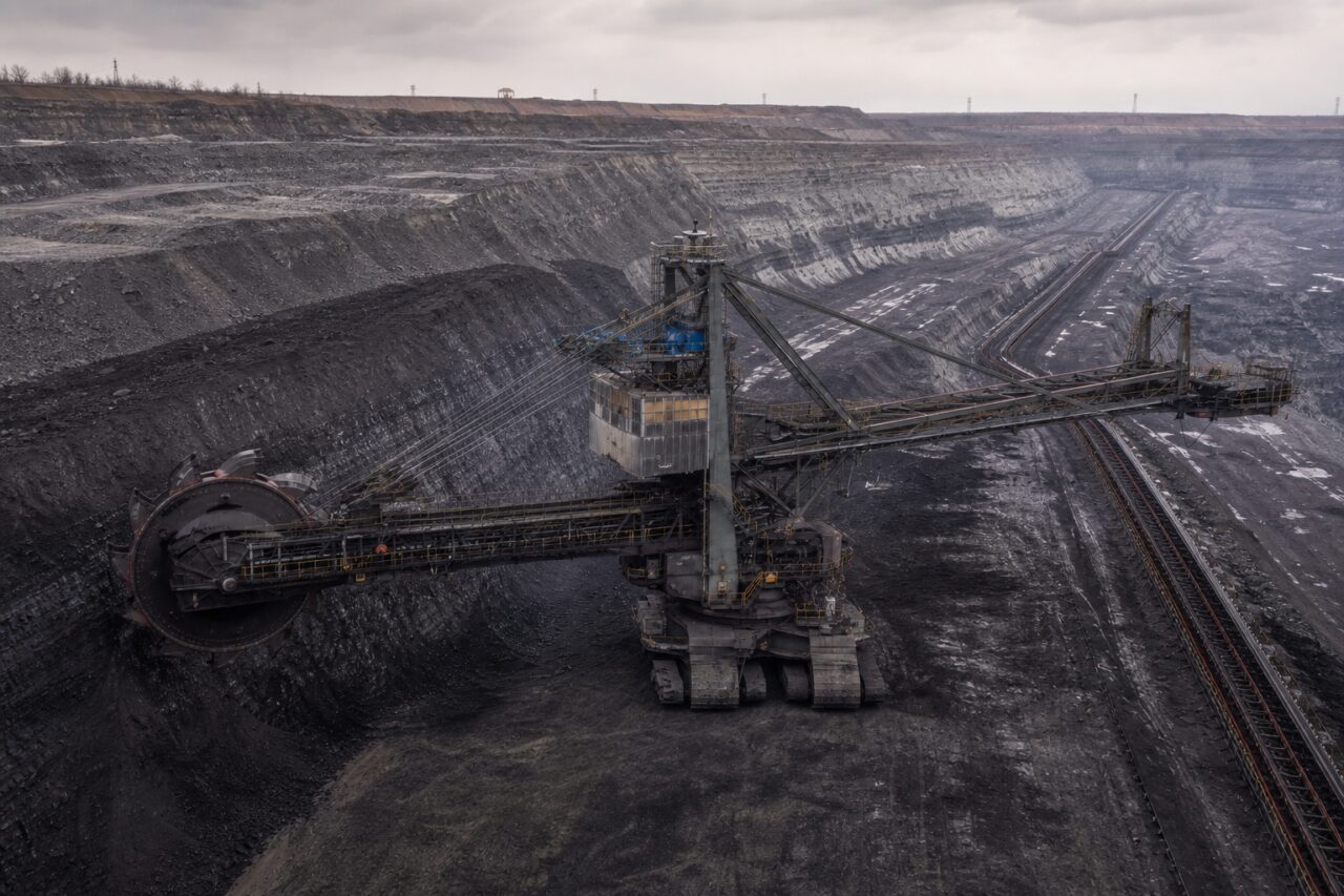 Giant bucket-wheel excavator and conveyor across an open-pit coal mine