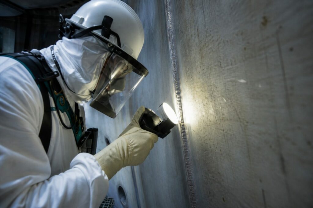 Reactor-vessel wall inspection — with a lamp aimed at a weld seam