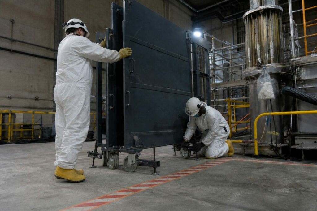 Technicians positioning a mobile radiation shield